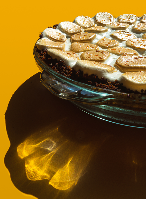 A close-up of a smores pie on a yellow background