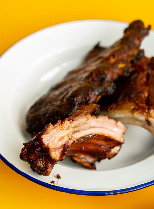 A close up of spareribs on a white plate